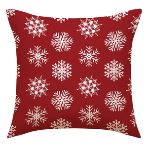 Detailed view of red Christmas pillowcase with white snowflake pattern fabric texture