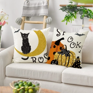 Linen Halloween pillow covers with black cat and pumpkin prints on a beige sofa