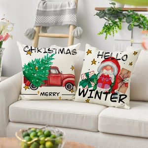 Detail von zwei weihnachtlichen Leinenkissenbezügen mit rotem LKW- und Wichtel-Illustration