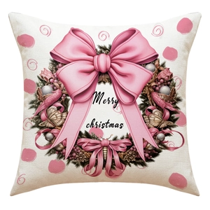 Détail d'une housse de coussin de Noël en lin avec couronne à nœud rose et texte Merry Christmas