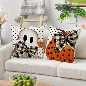 Halloween pumpkin and ghost pillow covers set on white sofa with rustic home decor