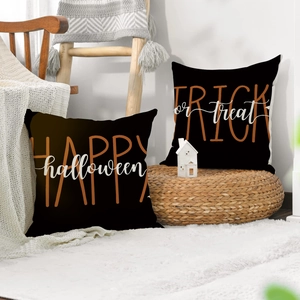 Detail of Halloween pumpkin pillow cover with Happy Halloween text on woven fabric