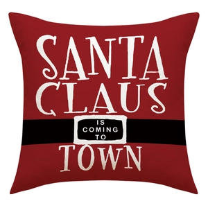 Close-up of red Christmas pillow case featuring Santa Claus is Coming to Town text