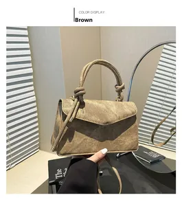 Close-up of brown gradient handbag with knotted handle and retro metallic buckle