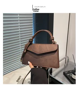 Close-up of coffee brown matte faux leather handbag with unique decorative handle knots