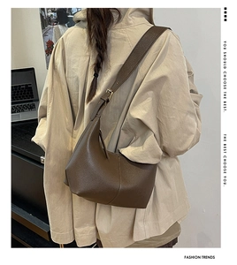 Brown lychee leather hobo bag with adjustable wide strap shown on a model