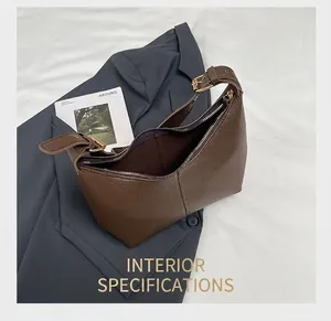 Detail view of the interior space and zip closure on the brown leather dumpling shoulder bag