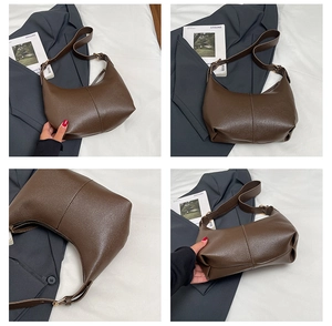 Detail view of dark coffee leather shoulder bag with pebbled texture and gold hardware