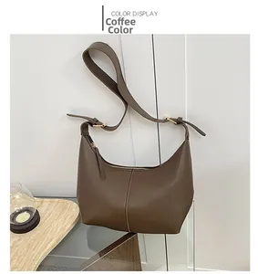 Close-up of coffee brown leather dumplings bag featuring premium lychee grain texture