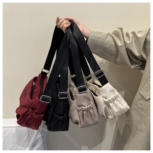 Detailed view of adjustable nylon shoulder straps and metal buckles on versatile bags