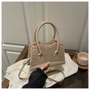 Detail of beige fleece patchwork tote bag with wavy lid and adjustable strap