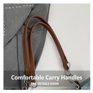Detail of premium brown leather handle with silver metal chain on printed tote bag