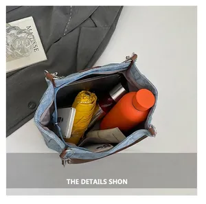 Blue denim tote bag showing large capacity storage with umbrella, bottle and tablet