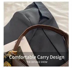 Detail of dark brown lychee leather handbag with decorative silk scarf on handle