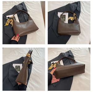 Detail view of large dark brown lychee leather tote bag with decorative floral scarf
