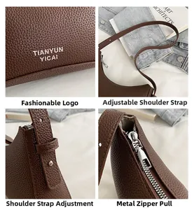 Detail view of lychee pattern leather underarm bag with silver hardware and logo