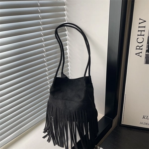 Sac seau minimaliste en daim noir avec de longues franges et de fines bandoulières