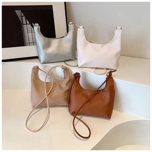 Minimalist faux leather hobo bags displayed in silver, cream, beige, and dark brown