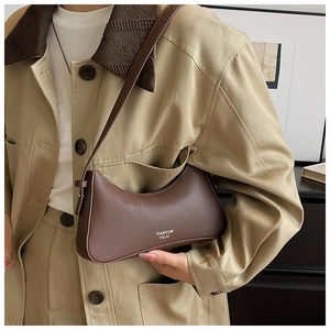 Detailed texture of brown lychee grain leather underarm bag with subtle logo print