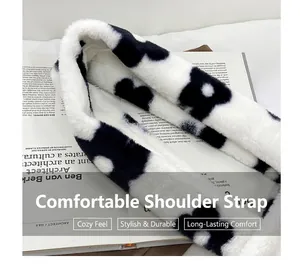 Detail view of plush faux fur shoulder strap with black and white floral pattern