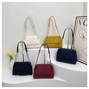 Detailed display of five colorful quilted chain shoulder bags on white display stands