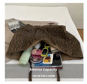 Internal capacity of the leopard print canvas tote showing tablet, water bottle and essentials