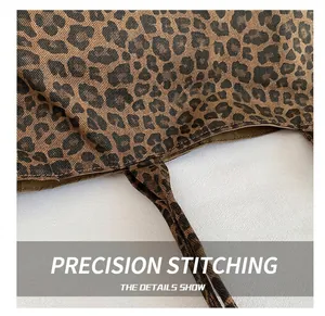 Macro detail showing tight stitching and fabric texture on a leopard print tote bag