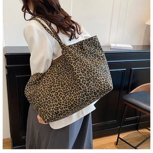 Detail of spacious leopard print canvas tote bag showing the fabric texture and strap