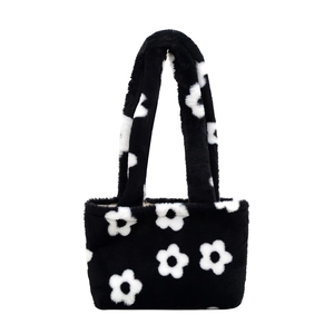 Minimalist black plush tote bag with white flower pattern and soft faux fur texture