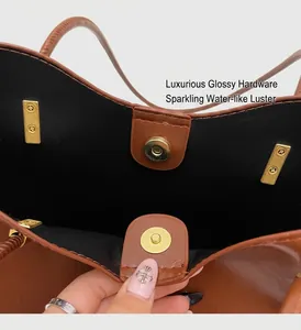 Macro shot of gold magnetic clasp and premium leather lining on a brown tote bag