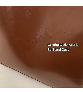 Close-up of brown oil-wax leather texture with glossy finish on a tote bag