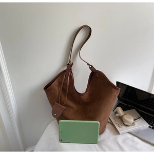 Brown suede tote bag detail with matching mini pouch and interior space for a tablet