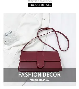 Detail view of the wine red leather crossbody bag with adjustable shoulder strap