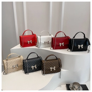 Collection of small crossbody bags with metallic bow clasps in seven different colors