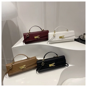 Detail of four crocodile embossed leather handbags with elegant gold metal twist locks