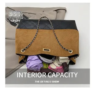 Detail view of large tote bag interior with metal chain showing spacious capacity