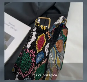 Detailed close-up of colorful snakeskin texture and golden square hardware on handbag