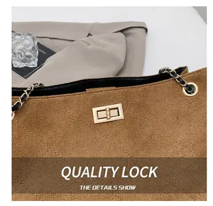 Detail shot of the vintage brown quilted suede tote featuring a gold metal twist lock