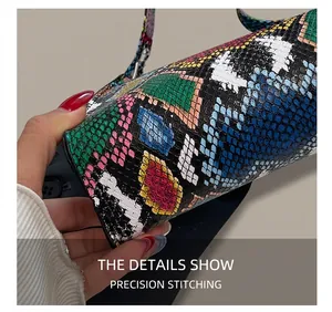 Macro shot showing precise stitching and colorful crocodile texture on this small handbag