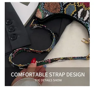 Close-up of the comfortable shoulder strap on a colorful crocodile texture crossbody bag