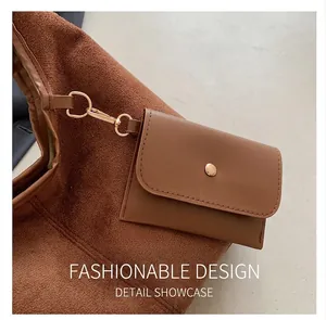 Detail of brown faux suede tote bag with a small detachable gold-buckled coin purse