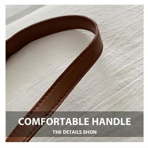 Detail of brown leather strap with fine stitching on minimalist suede tote bag