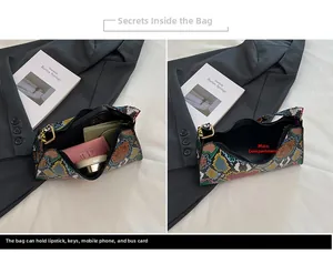 Detail view of colorful snakeskin leather bag interior holding phone and cosmetics