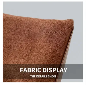 Detail of brown faux suede fabric with precise dark leather piping and neat stitching