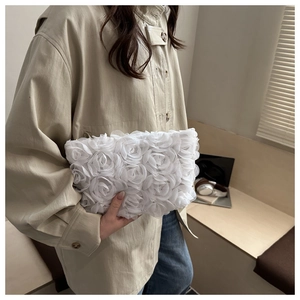 Detail of white 3D rose petal texture on romantic bridal clutch evening bag