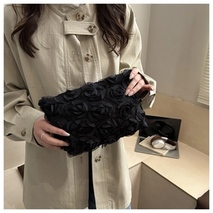 Close-up of elegant black mesh handbag with 3D rose flower petals for evening party