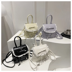 Mini ballet-style bucket backpacks featuring lace trim and bows in four soft colors