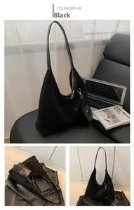 Detail of black large capacity hobo bag with matching detachable coin pouch and matte texture