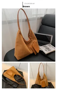 Brown faux suede hobo bag with matching coin purse shown in a lifestyle office setting
