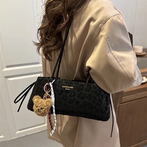 Chic leopard print underarm bag with cute bear charm and woven logo tag for women